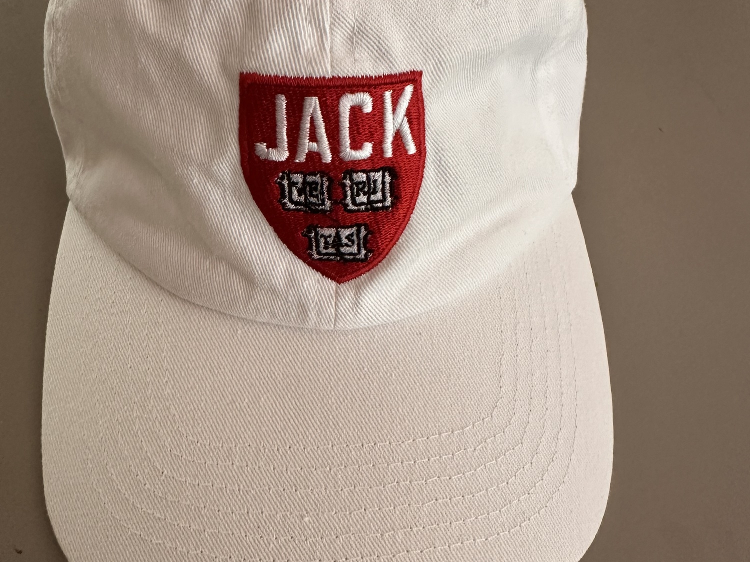 Custom Harvard hats embroidered with 'Jack' were given out at the October celebration honoring Reardon.