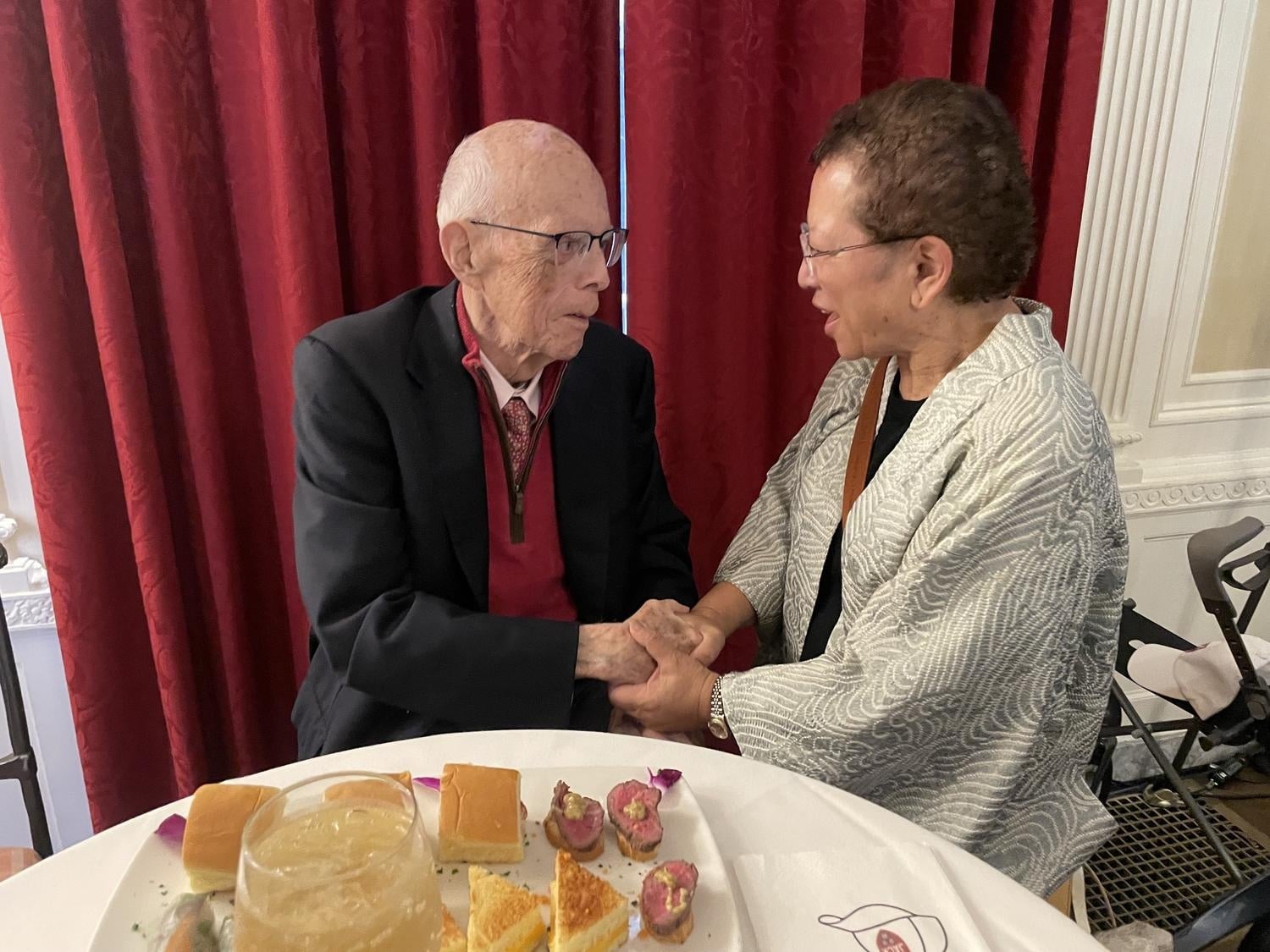 John P. 'Jack' Reardon Jr. '60 shakes hands with Yuki M. Laurenti '79 during an October celebration at Loeb House honoring Reardon's six decades at Harvard.