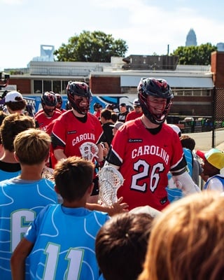 Cover image for Crimson Alumni Shine as PLL Comes to Harvard Stadium