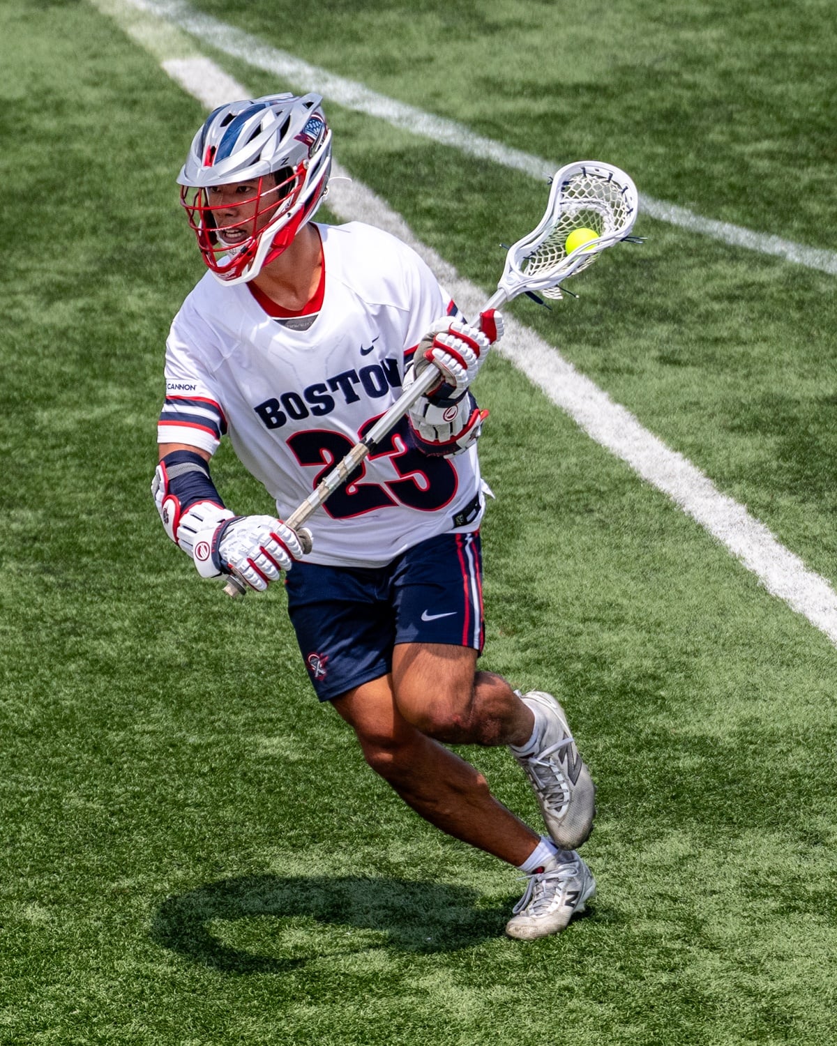Logan Ip '26 drives upfield during a game for the PLL's Boston Cannons. 