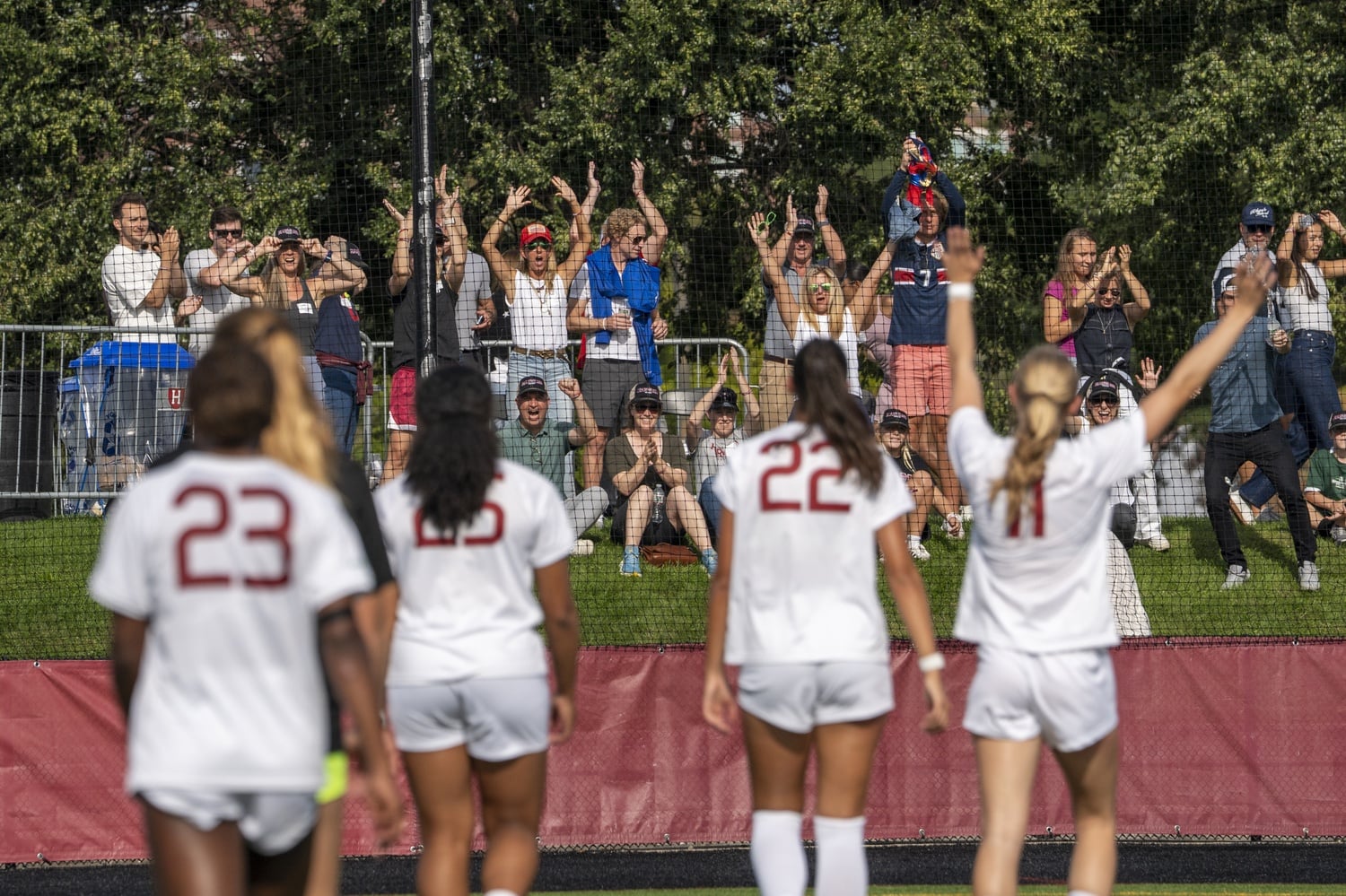 Harvard fans cheer for the women's soccer team on Jordan Field. 