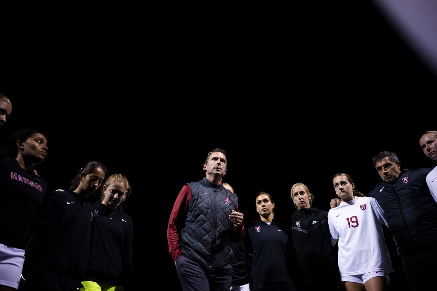 Chris Hamblin, the Head Coach of the women's soccer team, huddles with his players during a game against Brown in 2025. 