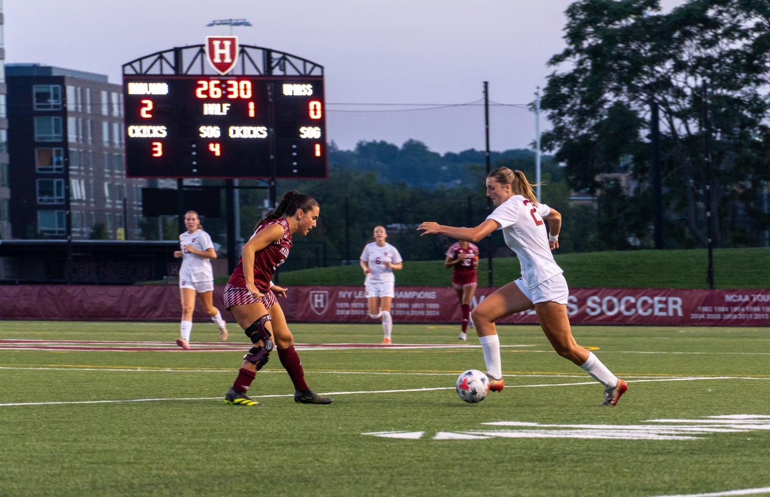 Harvard freshman Molly Vana attempts to get by a UMass defender.
