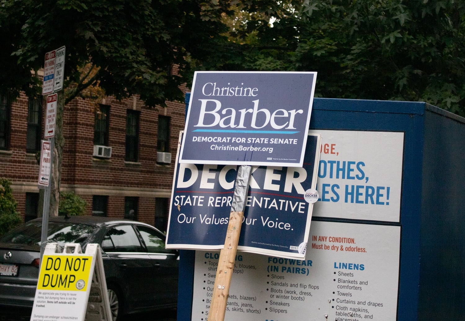 Campaign signs for state Senate candidate Christine Barber and state Rep. Marjorie C. Decker stand outside a Cambridge polling place on Tuesday. Both are competing in contested Democratic primaries.