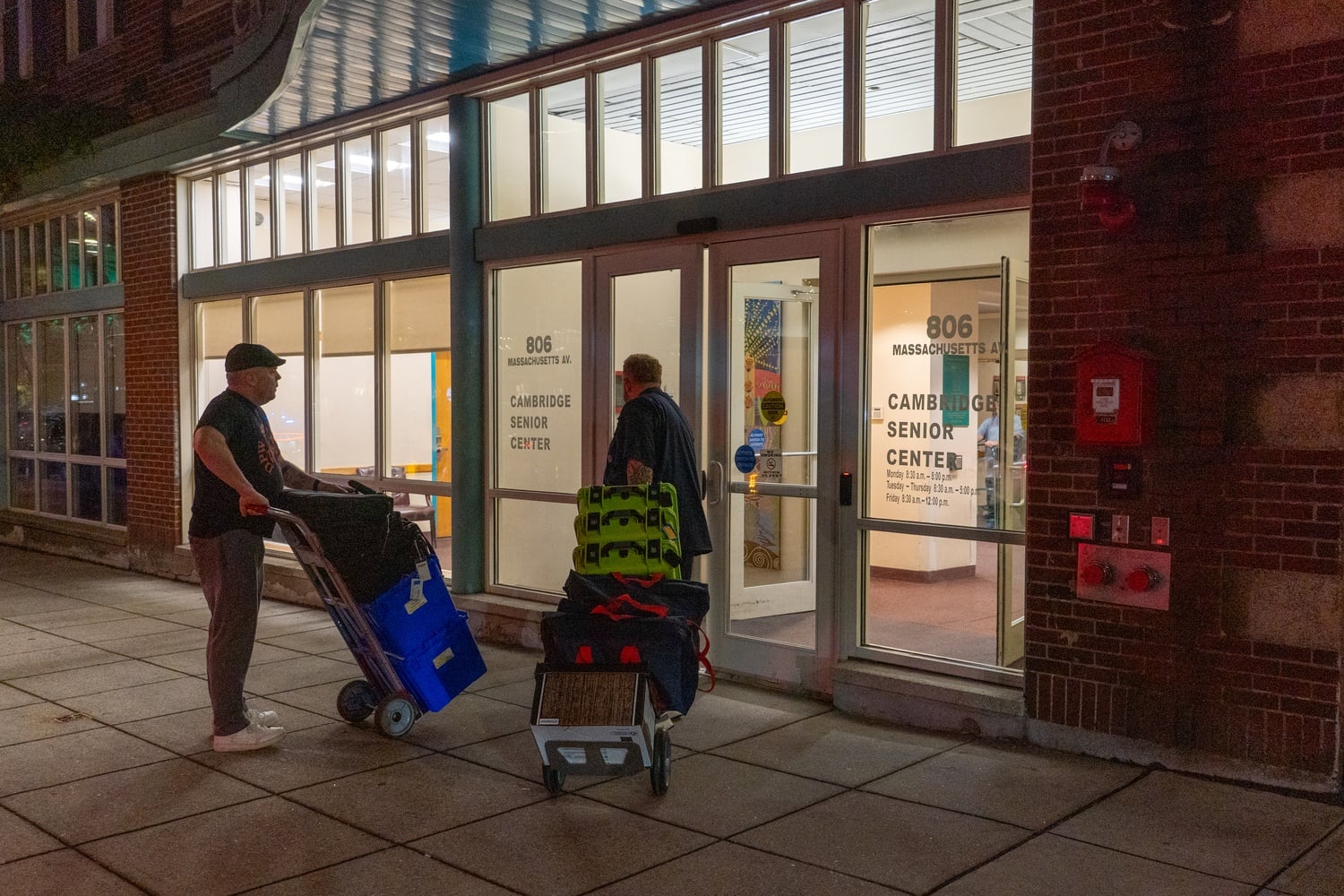 Election workers bring ballots into the Cambridge Senior Center on Massachusetts Avenue Tuesday night. The center served as a hub for vote counting after polls closed in the 2026 state primary.