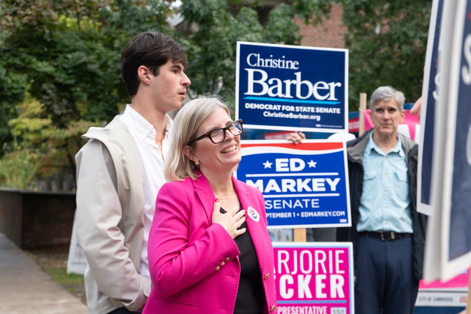 Supporters gather with campaign signs for state Senate candidate Christine Barber, U.S. Senator Ed J. Markey, and state Representative Marjorie C. Decker on primary Election Day. Campaigners greeted voters outside a polling location Tuesday.