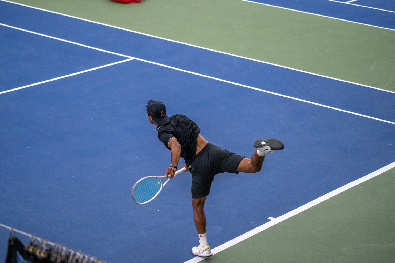 Masato Perera '26 unleashes a serve against the University of Pennsylvania last spring.  