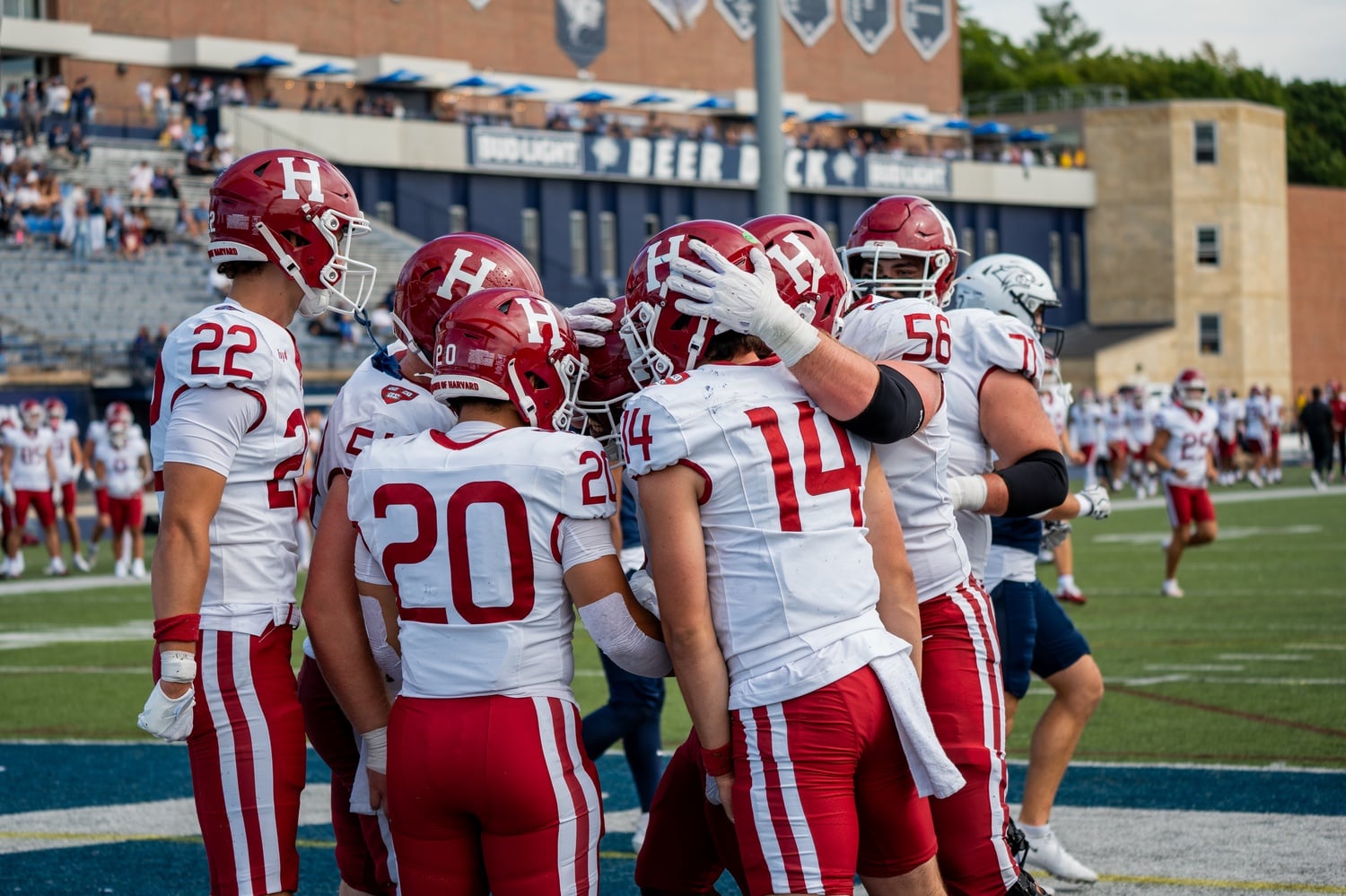 Harvard celebrates a touchdown in its 2026 season opener at New Hampshire.