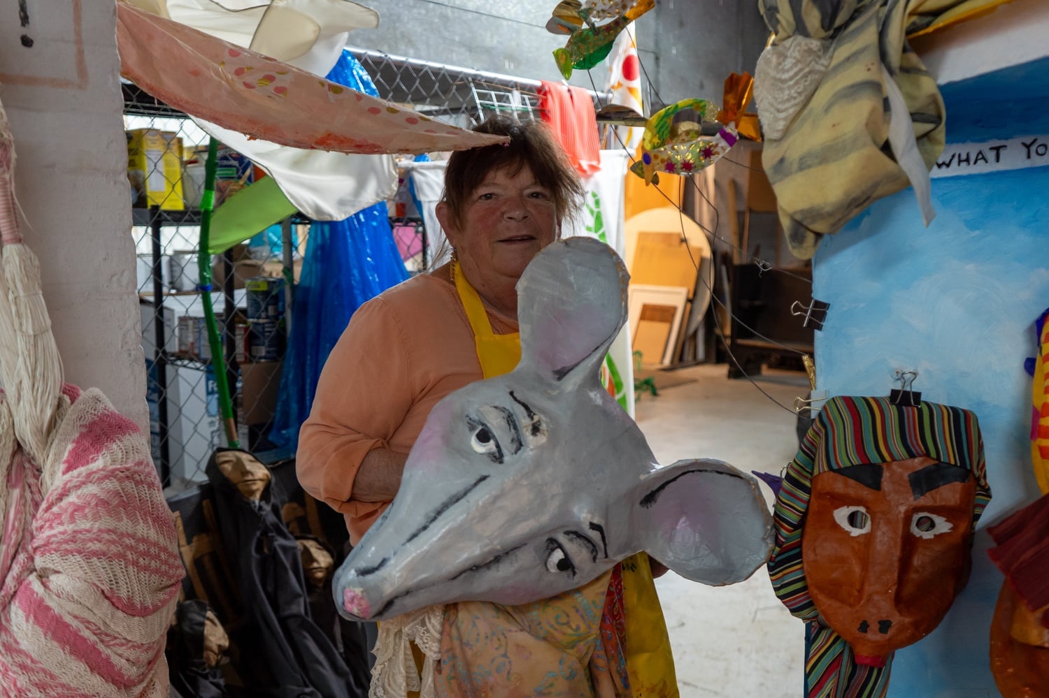 Sara Peattie stands inside the library with Ms. Mouse's head.