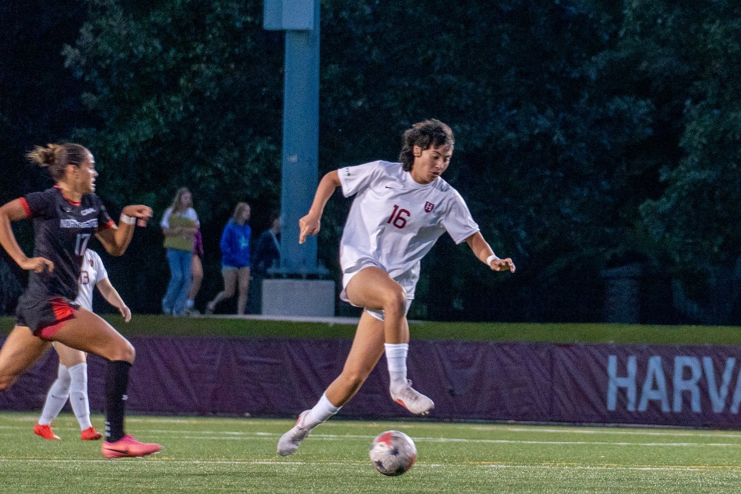 Senior Jasmine Leshnick evades a Northeastern defender during Harvard's 1-0 win over the Huskies earlier this season. Leshnick scored the Crimson's fourth goal over Princeton in its Ivy League opener.