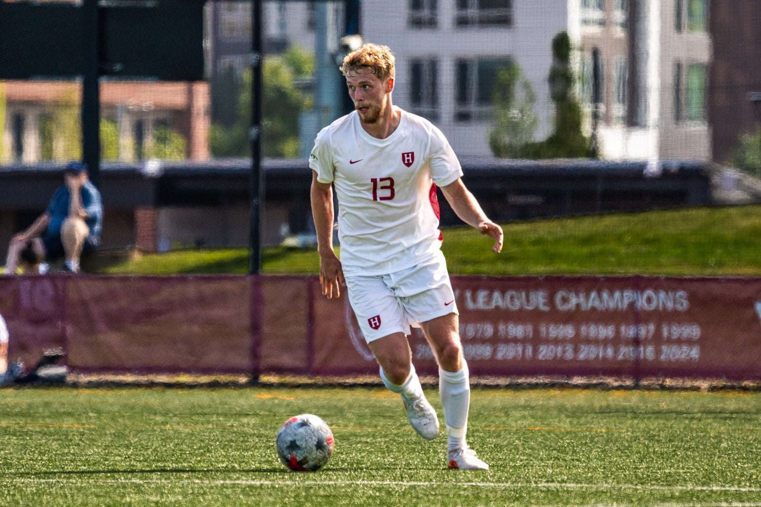 Junior defender Tim Langenbahn races up the field during Harvard's match against the University of Connecticut earlier this year. 