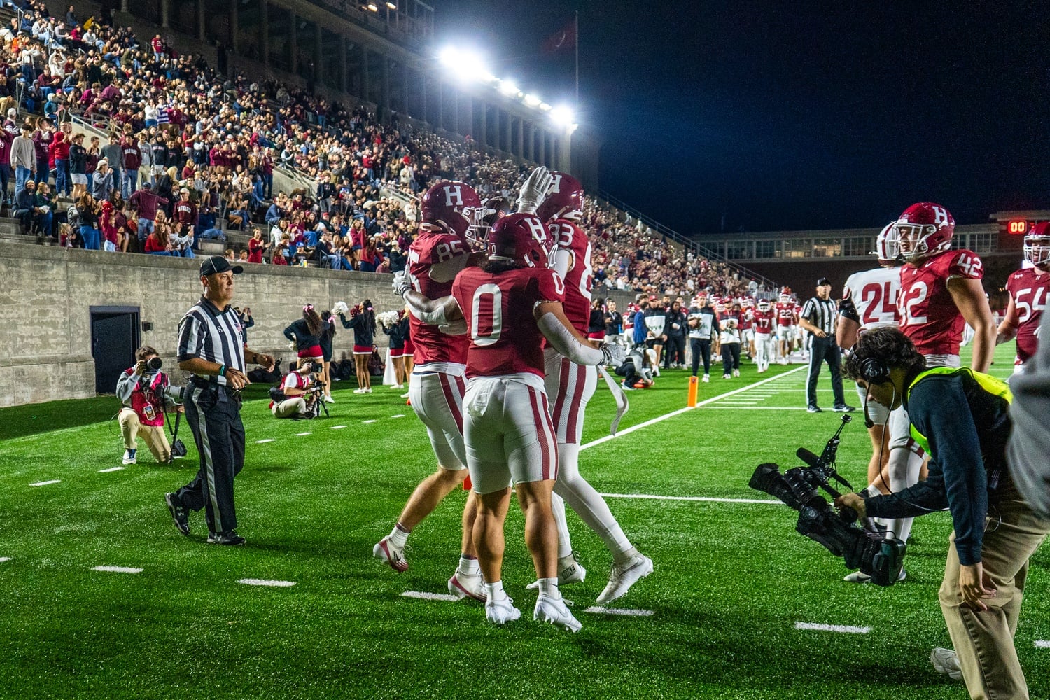 The Harvard football team celebrates a touchdown against the Colgate Raiders. 