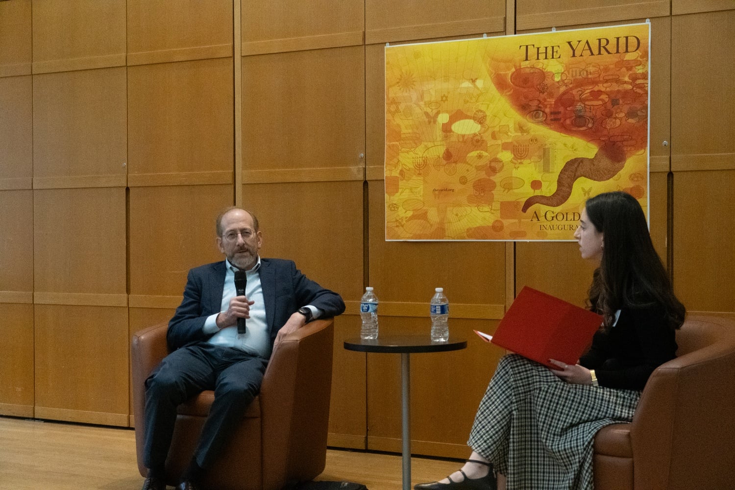 Harvard President Alan M. Garber '76 speaks with Hillel's undergraduate president Miram E. Goldberger '28 at a symposium celebrating the launch of YARID, a new student-run publication of Jewish thought.