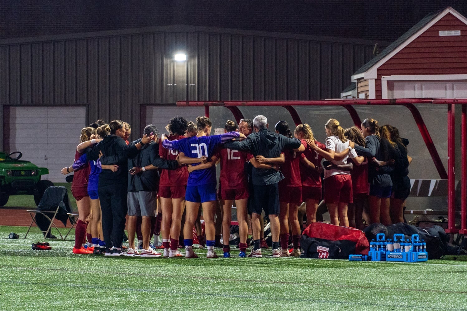 Harvard women's soccer huddles during its game against Boston University.