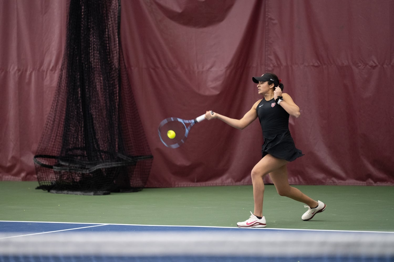 Senior Kavya Karra hits from the baseline in the Murr Center last winter. Karra and her doubles partner, senior Stephanie Yakoff, qualified for the NCAA Championships for the second time after winning the doubles draw of the ITA New England Regionals this past weekend. 