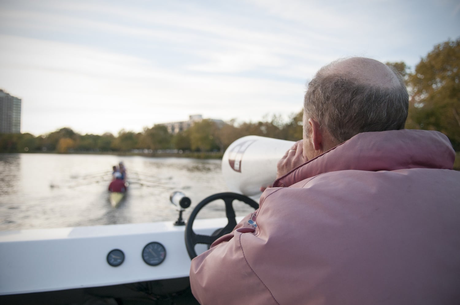 Charley Butt guides his team down the Charles River. 
