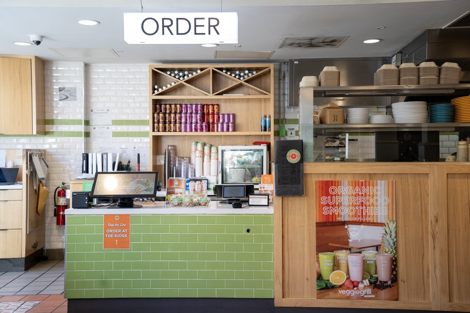 The bright lighting and decor of Veggie Grill give the restaurant a vibrant atmosphere.