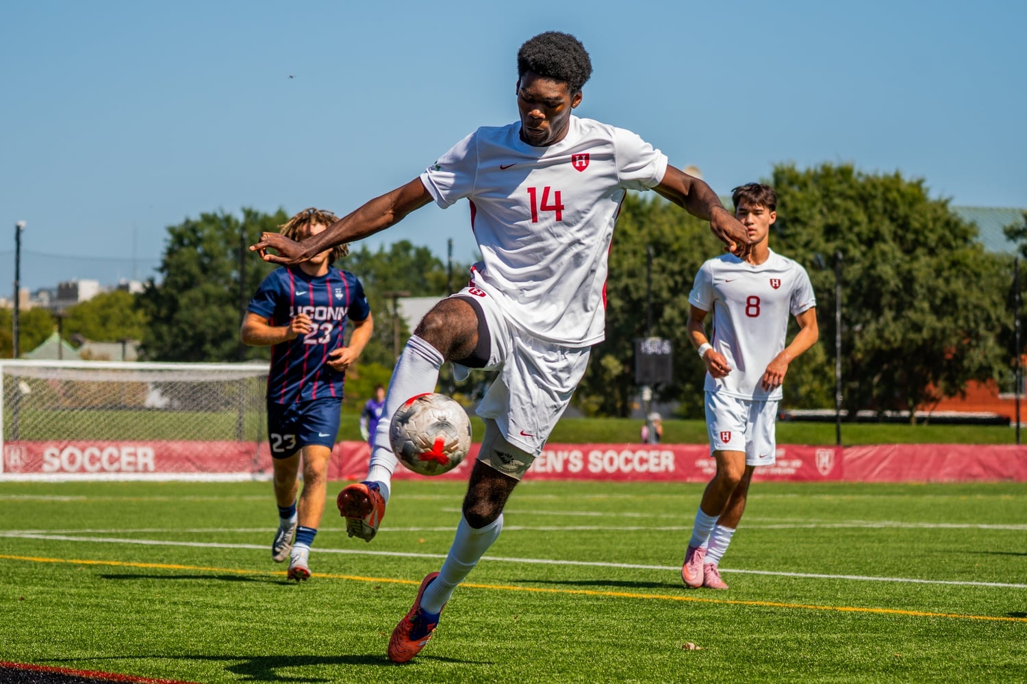 Junior forward Xavier Tanyi wrangles control of the ball during a match against the University of Connecticut. 