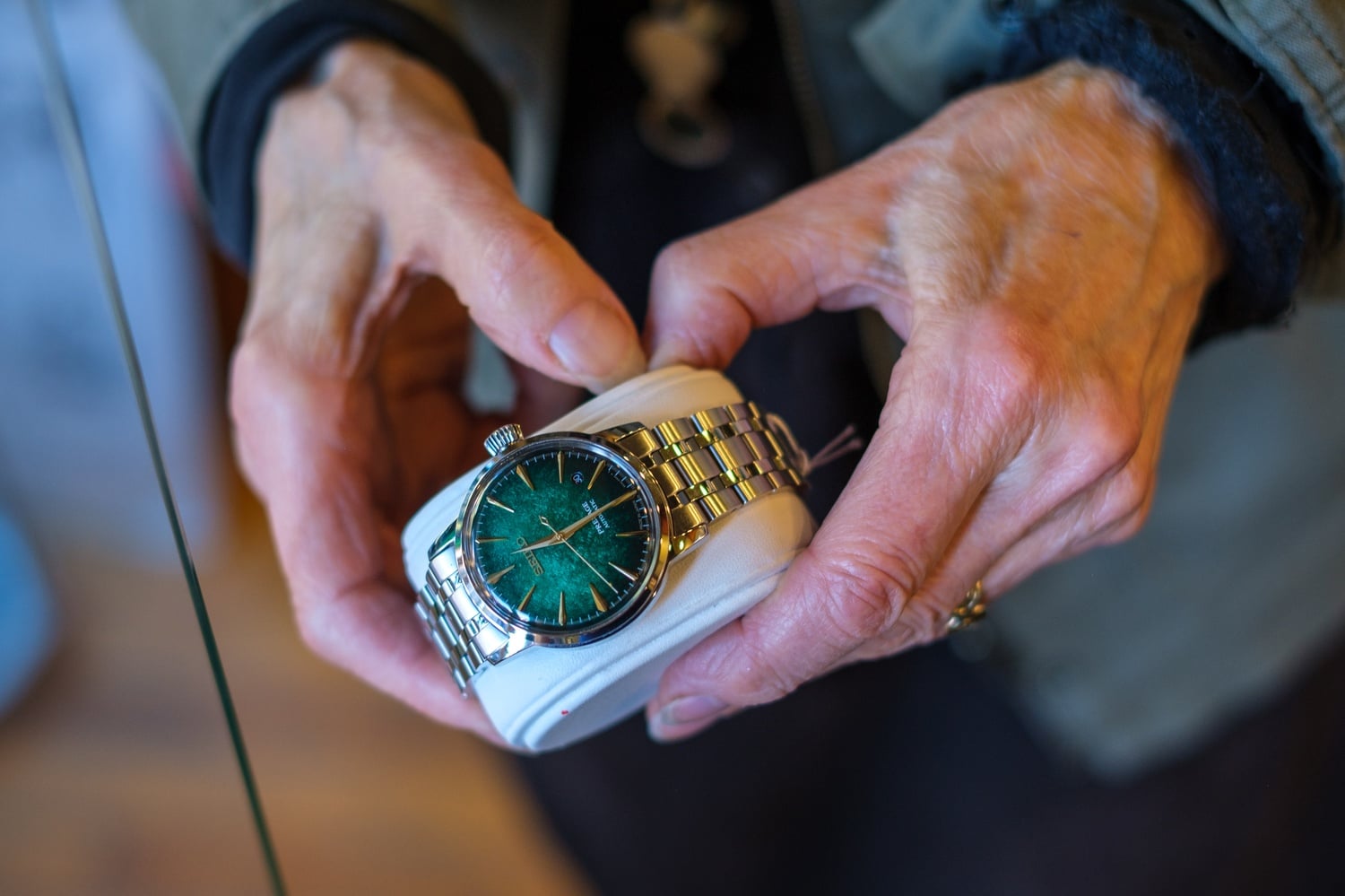 Susan Lelyveld holds a green Seiko watch.
