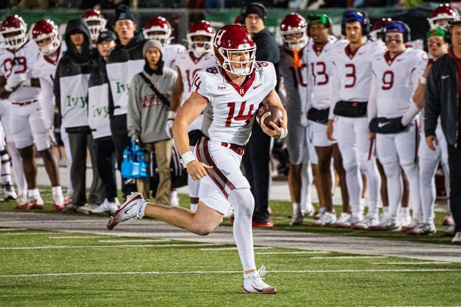 Sophomore quarterback Charlie Smith hustles along the edge of the field during the game against Dartmouth.